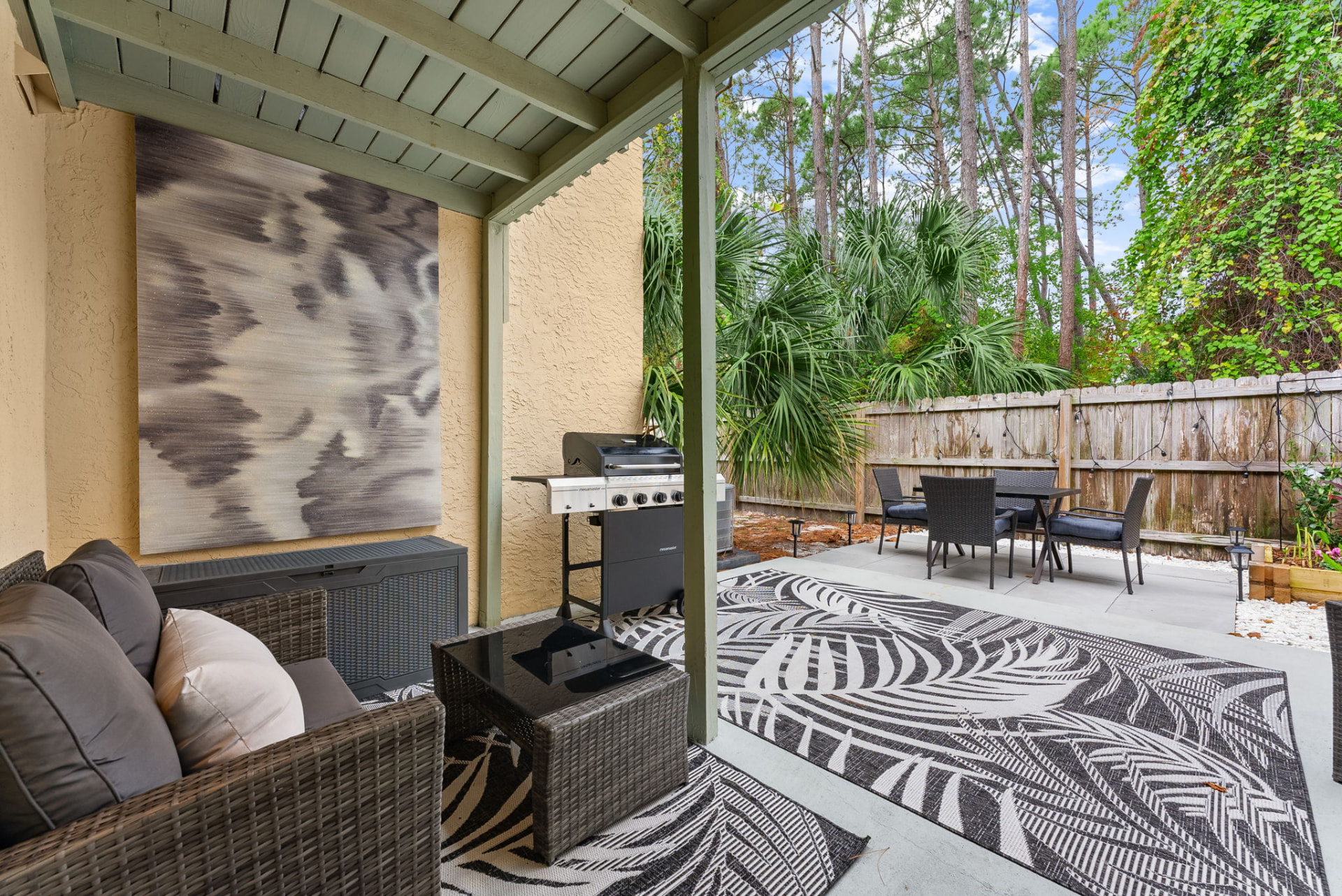 Covered patio with grill and outdoor dining