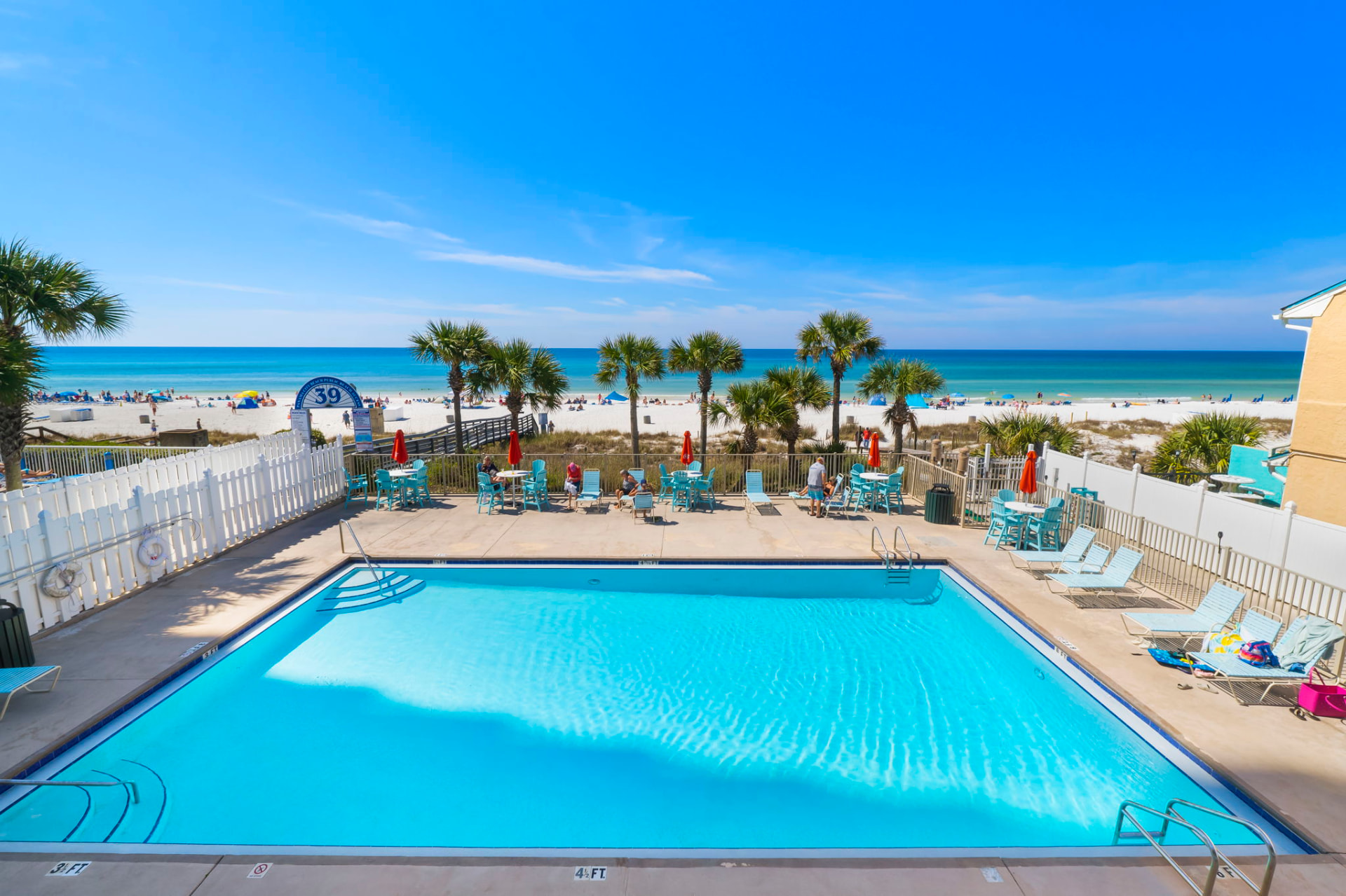 Community pool overlooking the white sand and Gulf water in Panama City Beach, Florida